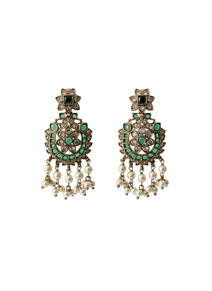 Antique gold dangle earrings featuring a floral stud, emerald green stones, clear crystals, and hanging pearl beads.